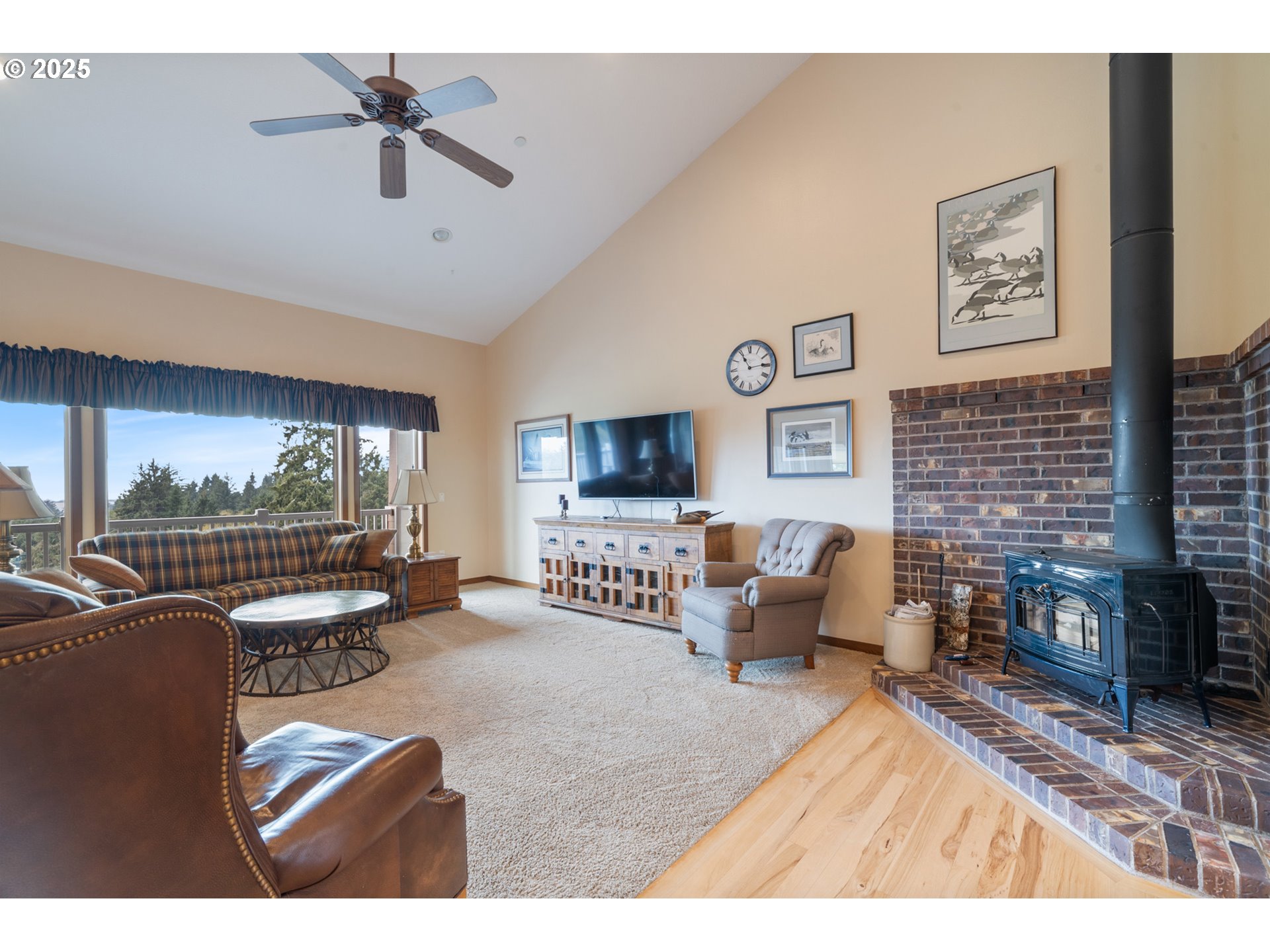 9500 Walz Hill Road Tillamook, OR 97141 - Photo 23 of 47 a living room with furniture tv and a fireplace