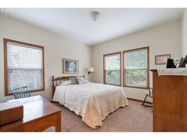 a bedroom with a large bed and a large window