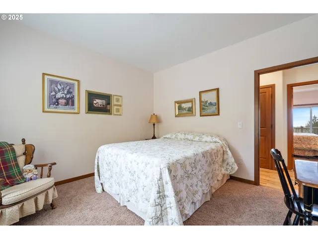 a bed room with a bed and a chair