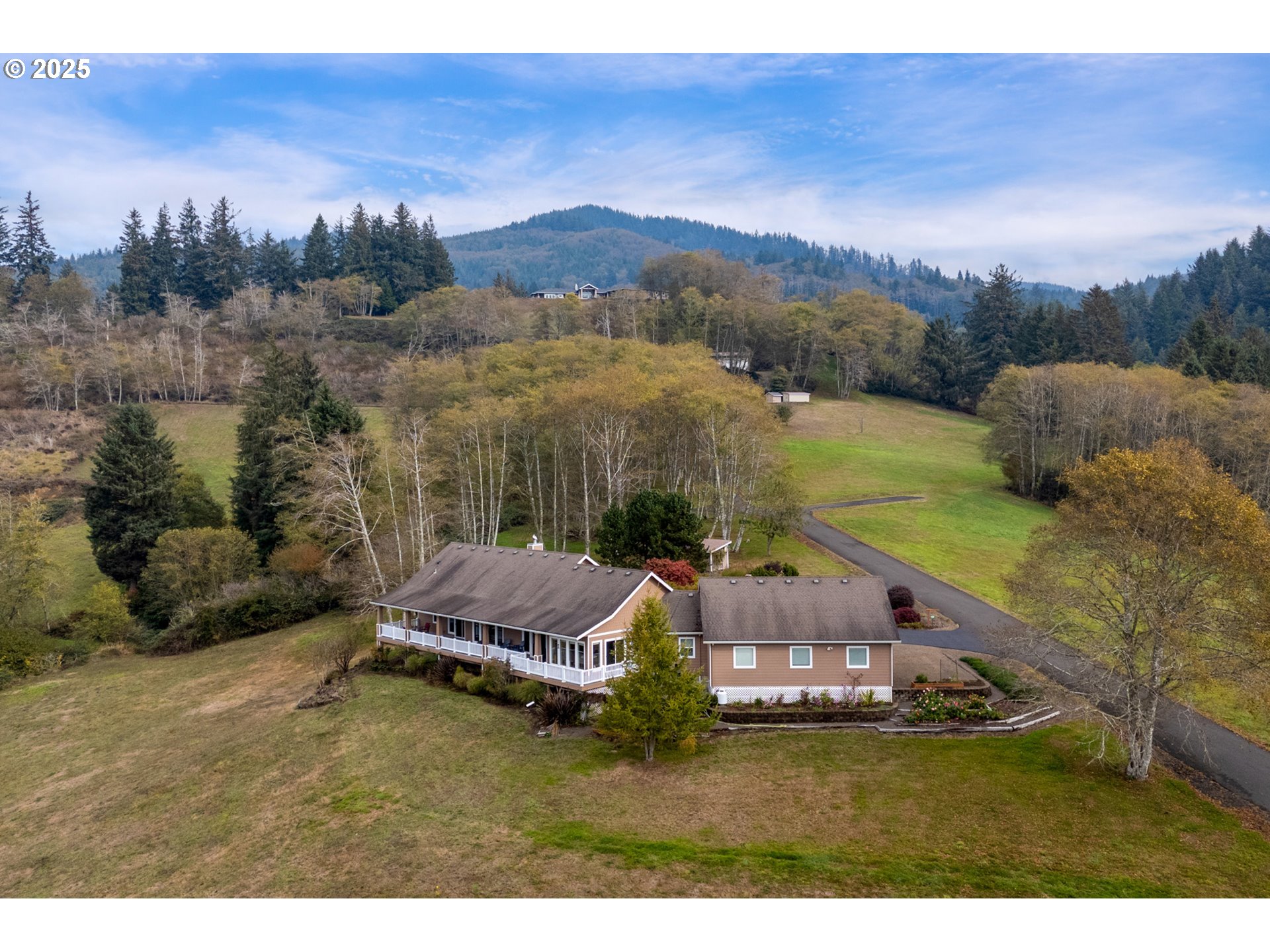 9500 Walz Hill Road Tillamook, OR 97141 - Photo 42 of 47 a view of a house with a yard and mountain