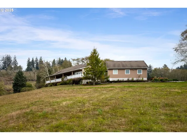 a tall yellow house with a yard in front of it