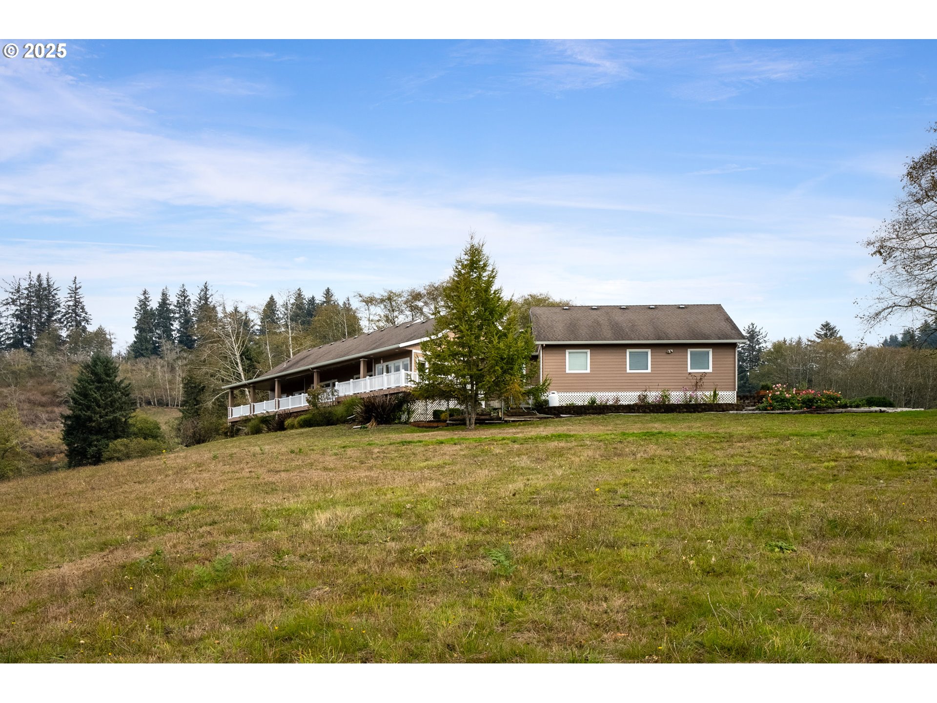 9500 Walz Hill Road Tillamook, OR 97141 - Photo 43 of 47 a tall yellow house with a yard in front of it