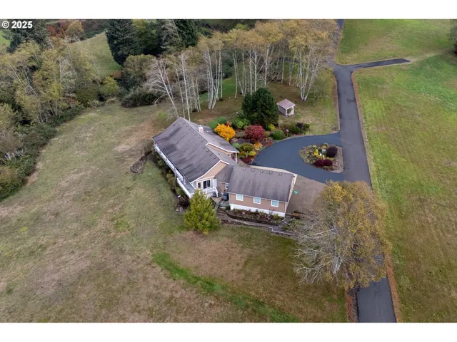 a aerial view of a house with a yard basket ball court