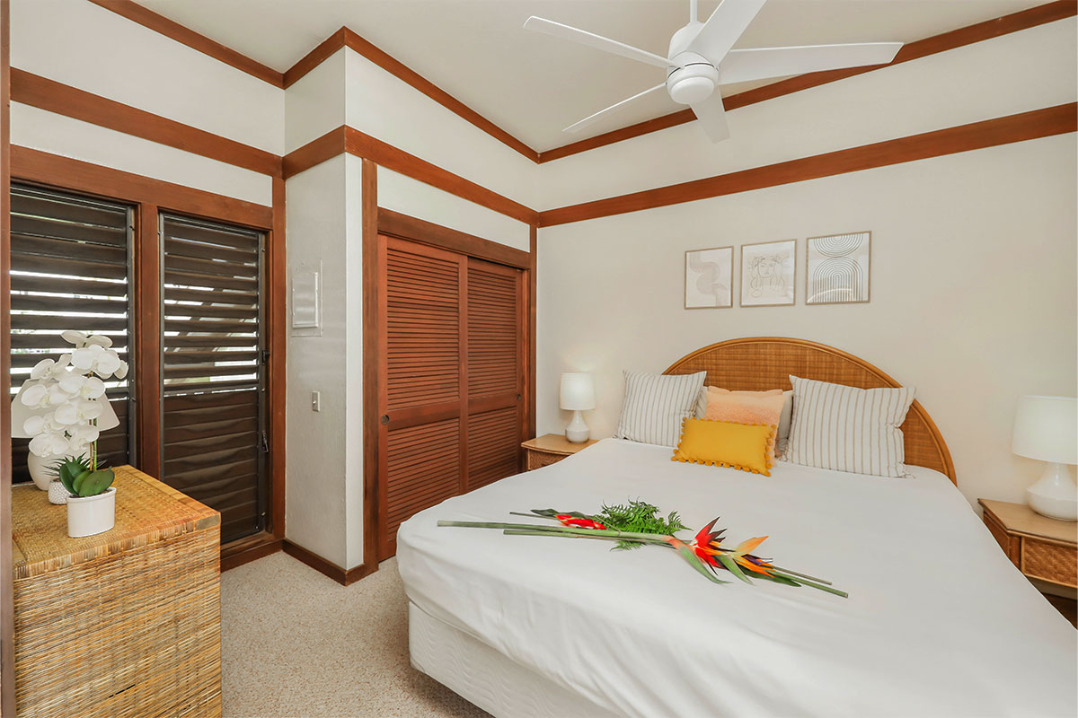 2253 Poipu Road, Unit 148 Koloa, HI 96756 - Photo 19 of 30 a bedroom with a bed and wooden floor