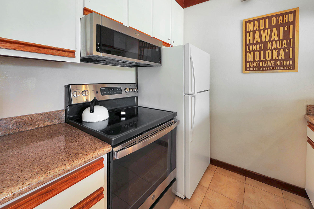 2253 Poipu Road, Unit 148 Koloa, HI 96756 - Photo 20 of 30 a kitchen with stainless steel appliances granite countertop a stove and a microwave