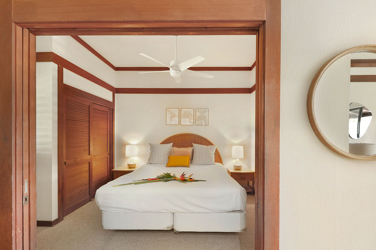 2253 Poipu Road, Unit 148 Koloa, HI 96756 - Photo 21 of 30 a bedroom with a bed and a mirror