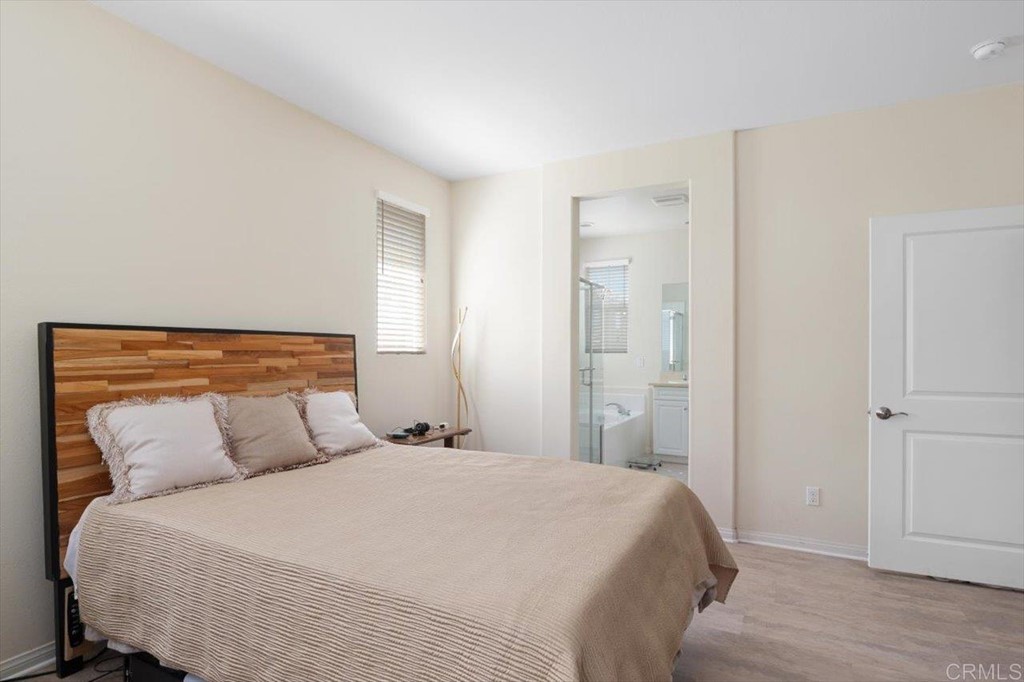 1347 Dolomite Way San Marcos, CA 92078 - Photo 12 of 23 a bedroom with a bed and wooden floor