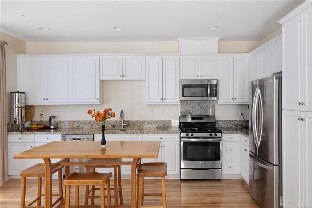 1347 Dolomite Way San Marcos, CA 92078 - Photo 7 of 23 a kitchen with stainless steel appliances a stove a sink a microwave and a refrigerator