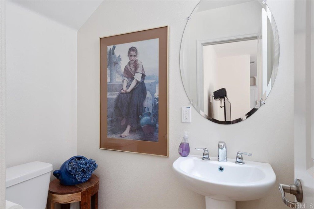 1347 Dolomite Way San Marcos, CA 92078 - Photo 9 of 23 a bathroom with a toilet a sink and a mirror