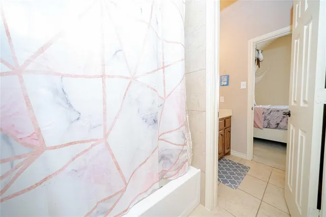 a bathroom with a tub and shower