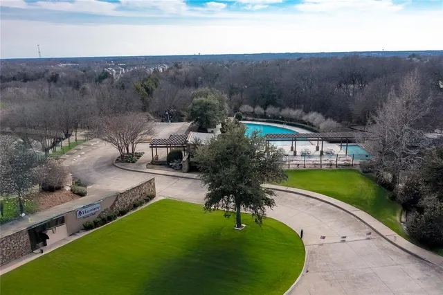 a swimming pool with outdoor seating and garden