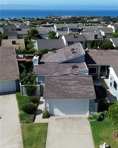 an aerial view of a house with a yard