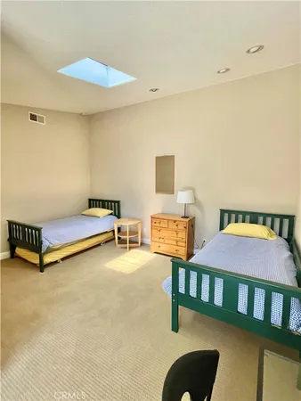 a bedroom with furniture and a rug