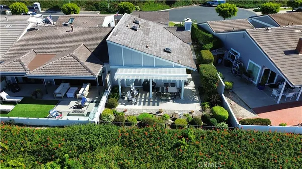 an aerial view of a house with swimming pool and garden