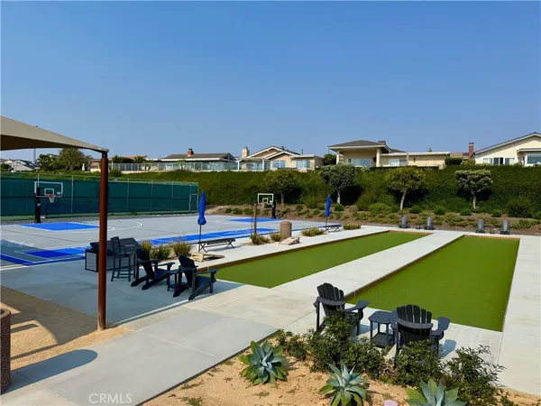a view of swimming pool with seating area and lake view