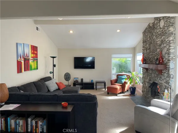 a living room with fireplace furniture and a flat screen tv