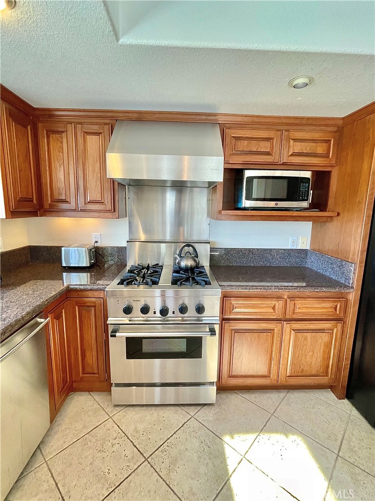 33581 Moonsail Drive Dana Point, CA 92629 - Photo 7 of 29 a kitchen with stainless steel appliances granite countertop a stove and a sink