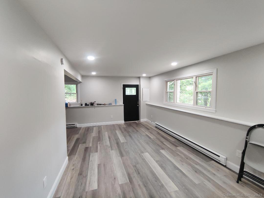 27 Paper Mill Road New Milford, CT 06776 - Photo 12 of 20 a view of empty room with wooden floor and window