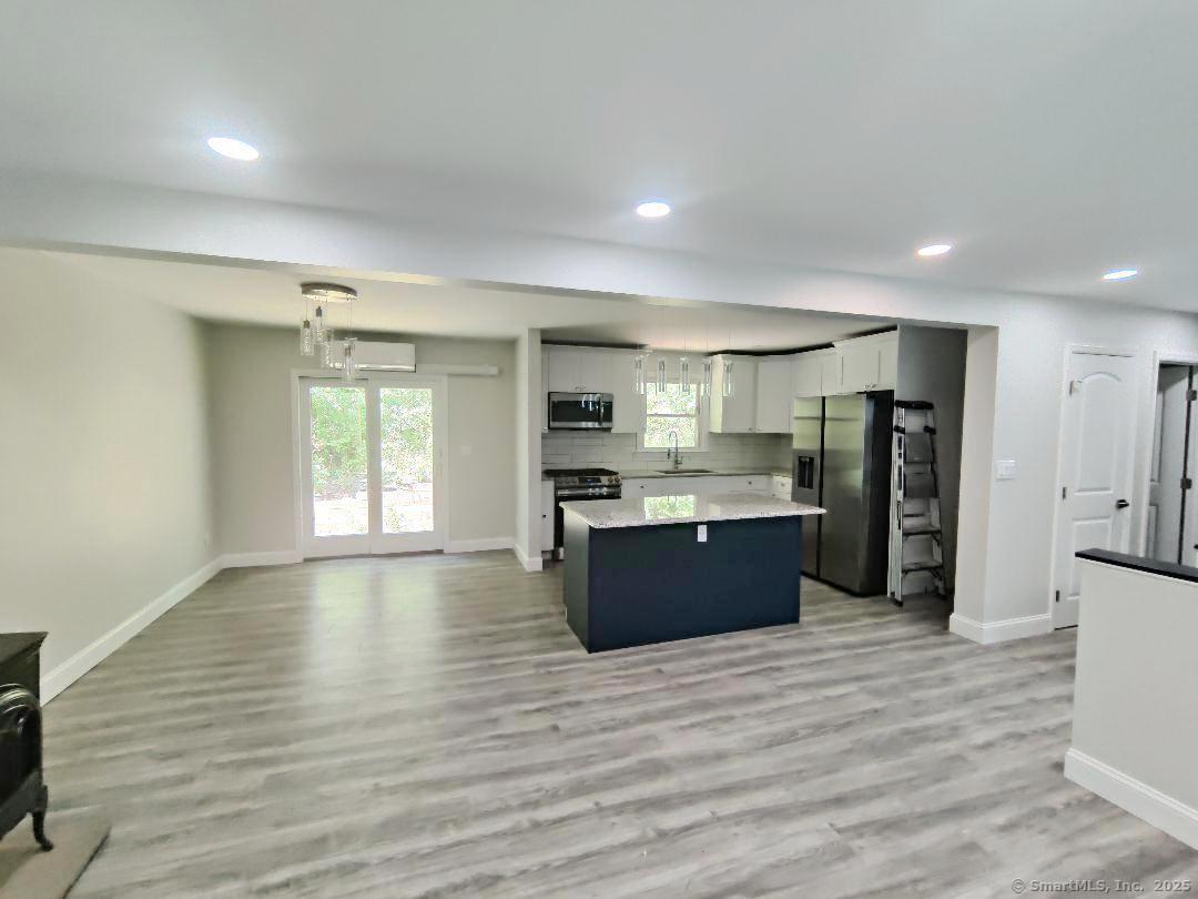 27 Paper Mill Road New Milford, CT 06776 - Photo 4 of 20 a large kitchen with stainless steel appliances kitchen island wooden cabinets and granite counter tops