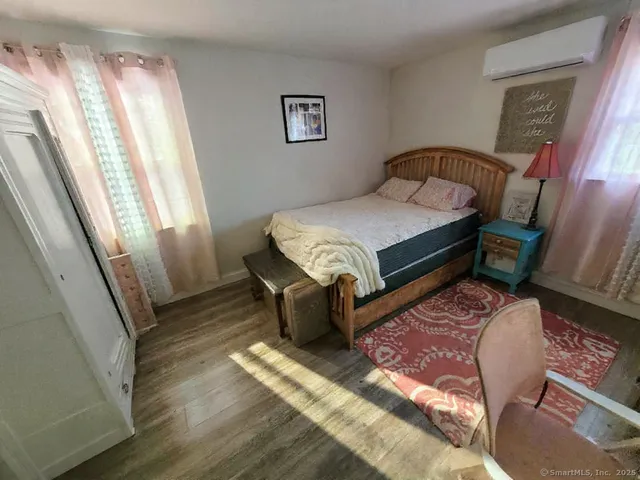 a bedroom with a bed and a mirror