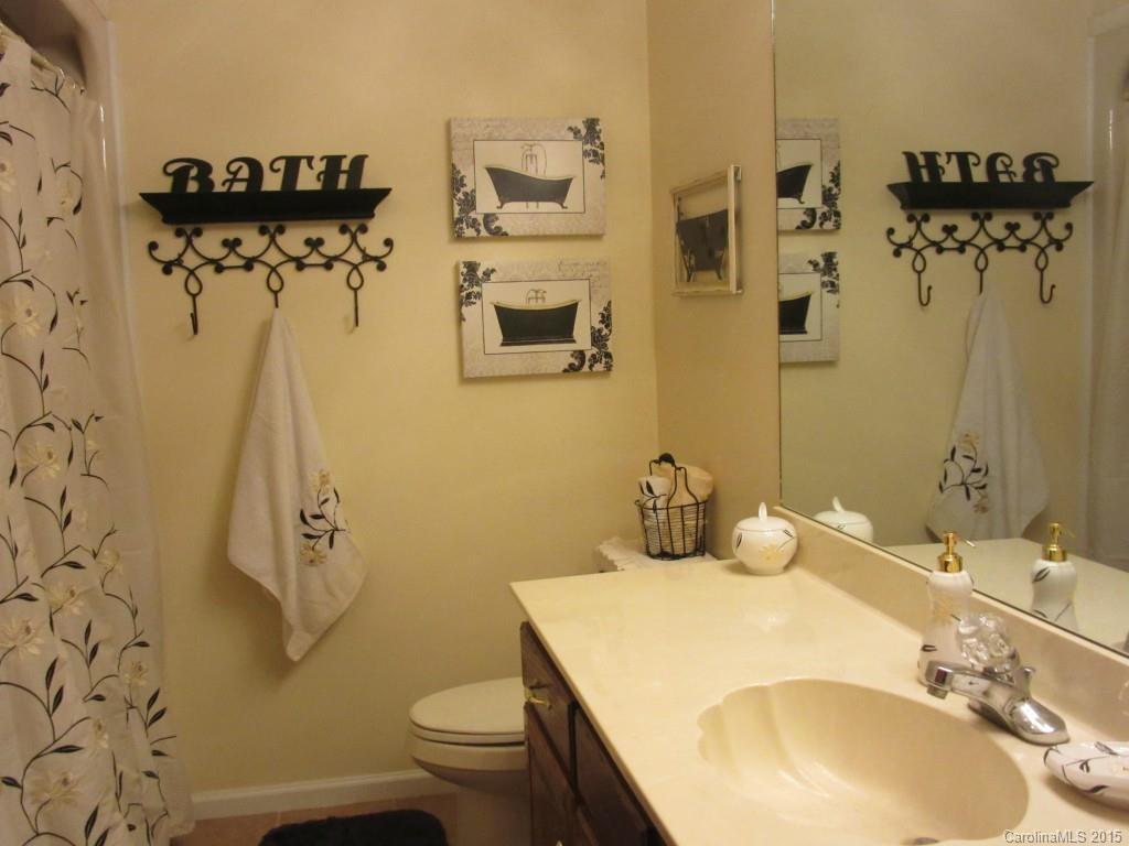575 Russell Farm Road Kannapolis, NC 28081 - Photo 14 of 23 a bathroom with a sink mirror toilet and shower