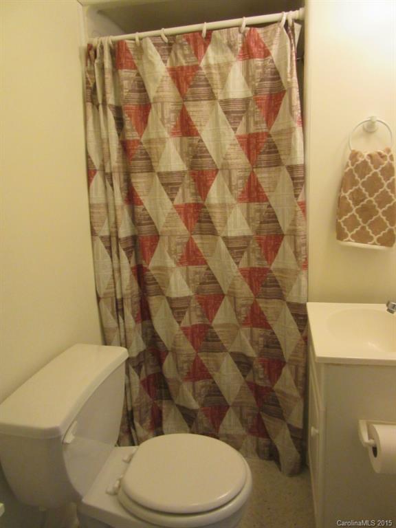 575 Russell Farm Road Kannapolis, NC 28081 - Photo 19 of 23 a white toilet sitting next to a shower curtain