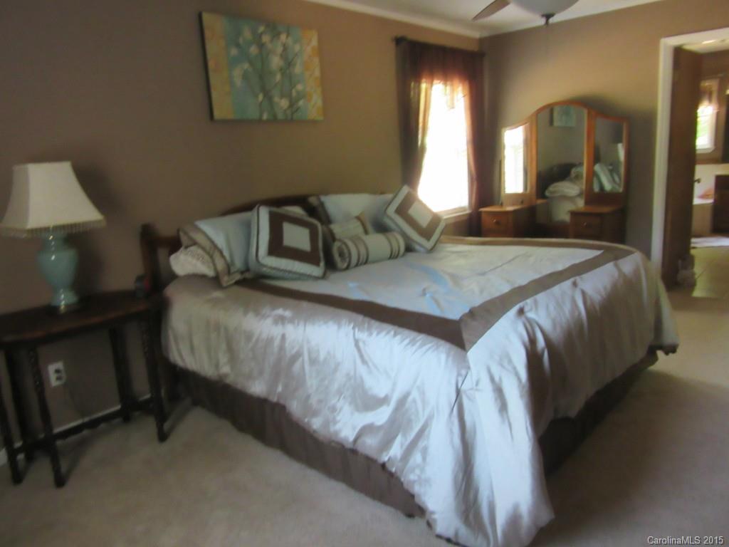 575 Russell Farm Road Kannapolis, NC 28081 - Photo 7 of 23 a bedroom with a bed and a large mirror on dresser