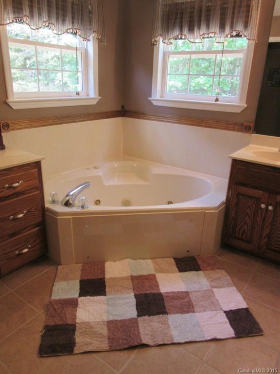 575 Russell Farm Road Kannapolis, NC 28081 - Photo 8 of 23 a white bath tub sitting in a bathroom next to a window