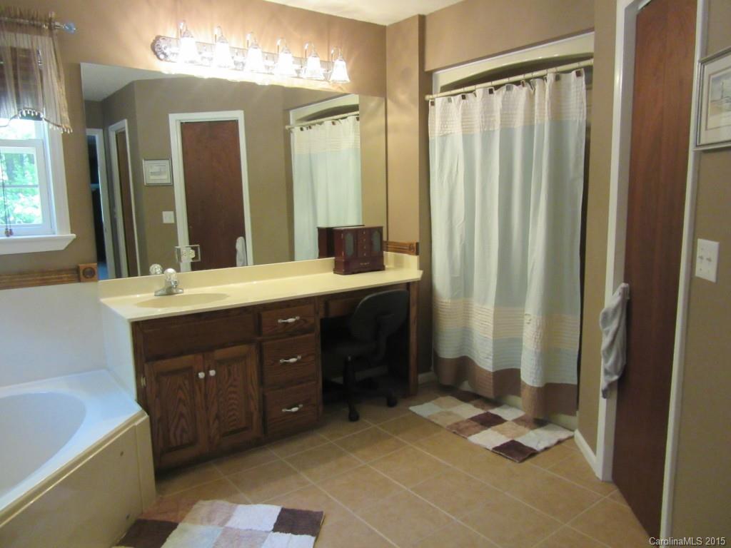 575 Russell Farm Road Kannapolis, NC 28081 - Photo 9 of 23 a bathroom with a mirror a double vanity sink and a mirror