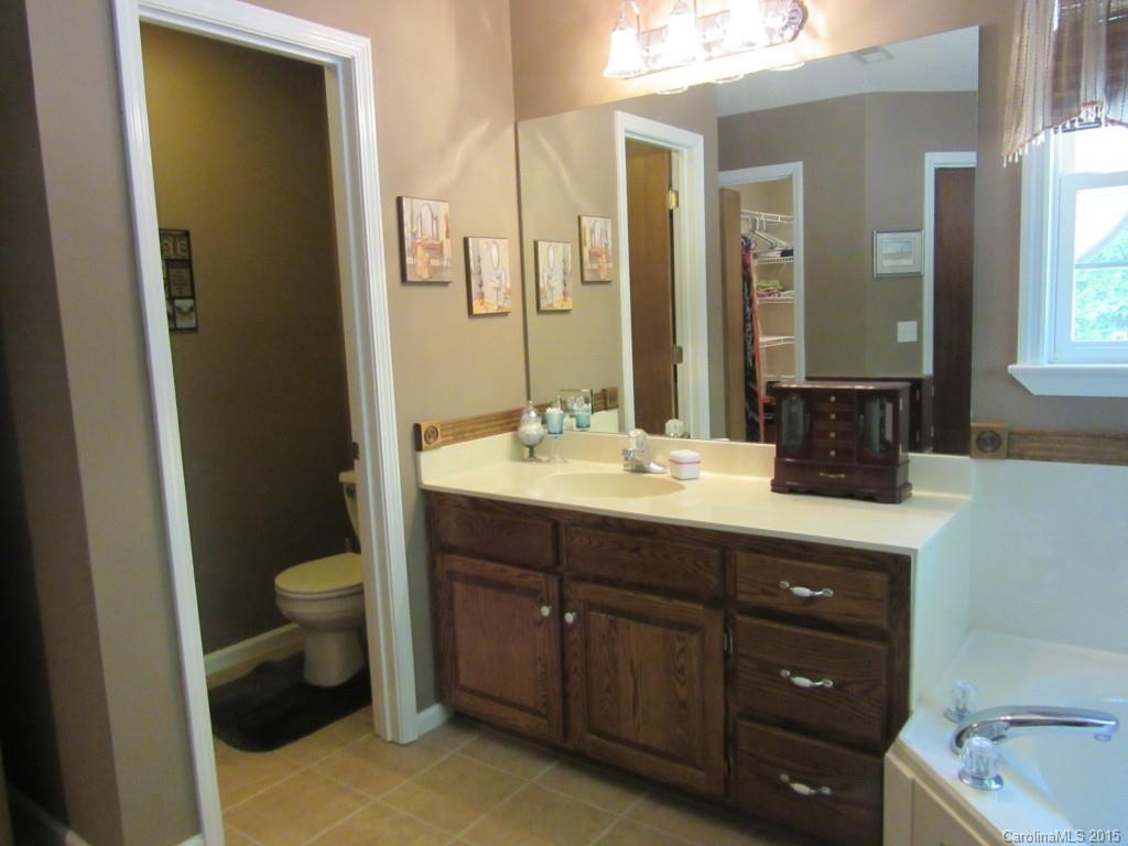 575 Russell Farm Road Kannapolis, NC 28081 - Photo 10 of 23 a bathroom with a sink and a mirror