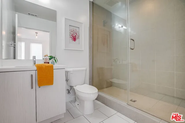 a bathroom with a shower and a toilet
