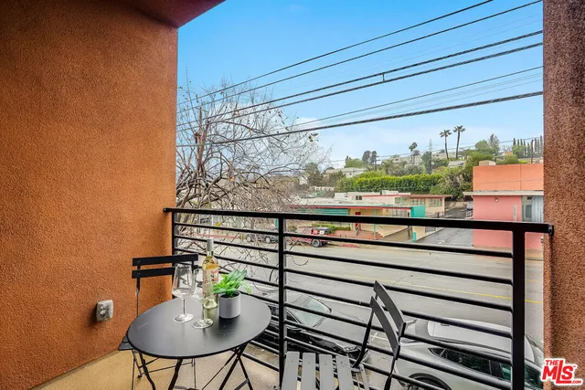 a view of a balcony with chairs and a table