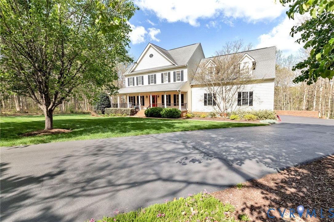14436 Overlook Ridge Lane Beaverdam, VA 23015 - Photo 4 of 82 a front view of a house with a yard and trees