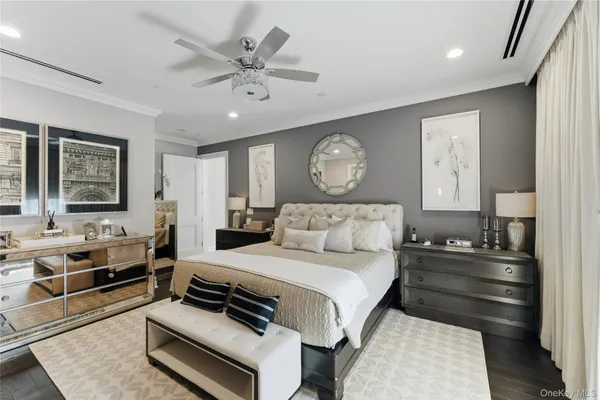 a bedroom with a bed and a mirror
