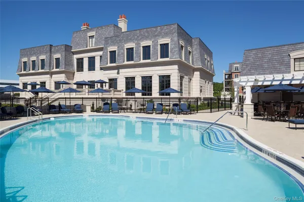 a swimming pool view with outdoor seating