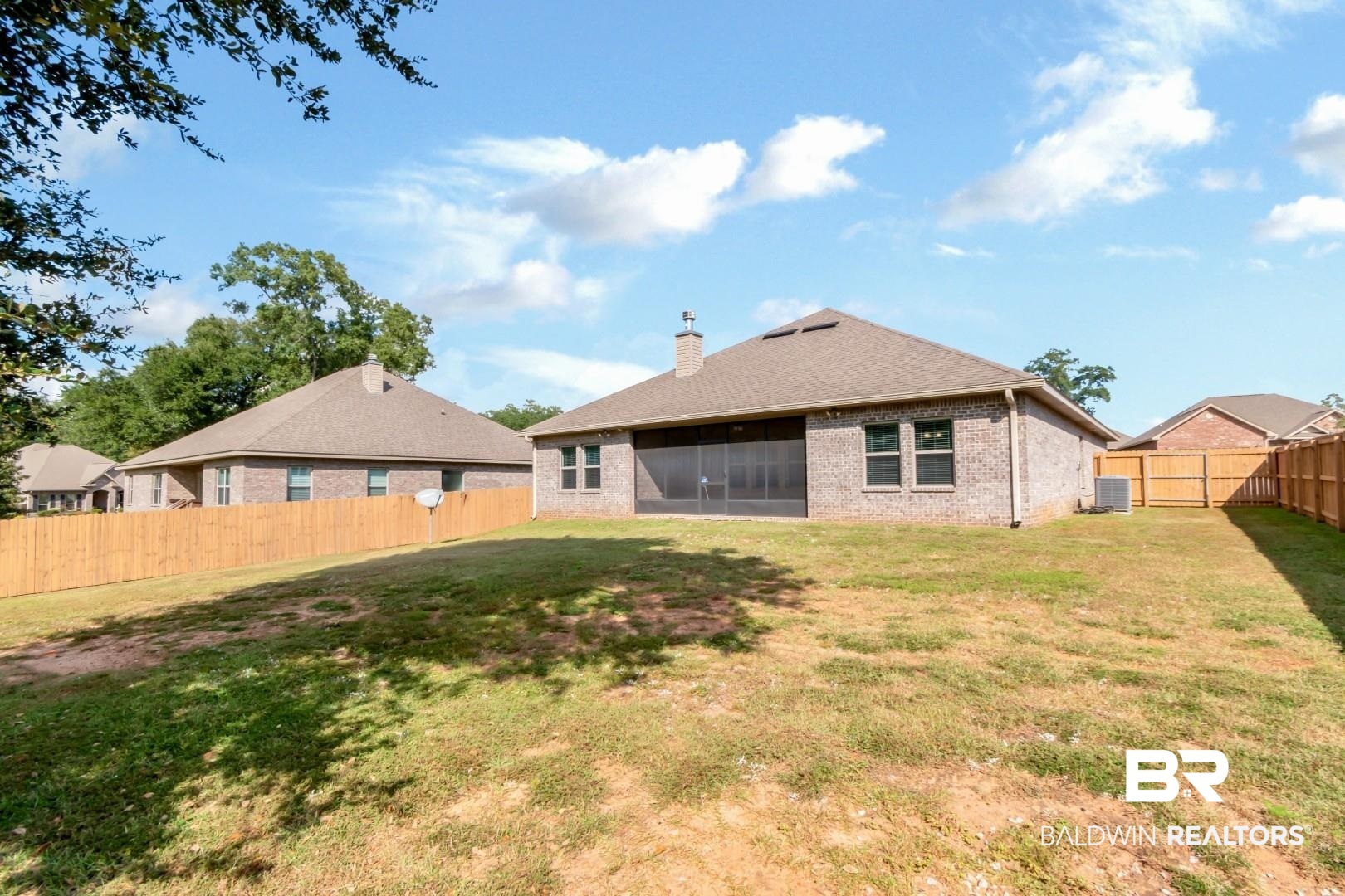 1282 Creek Ridge Court Mobile, AL 36695 - Photo 27 of 33 Rear view of house with a fenced backyard, a sunroom, brick siding, a chimney, and a shingled roof