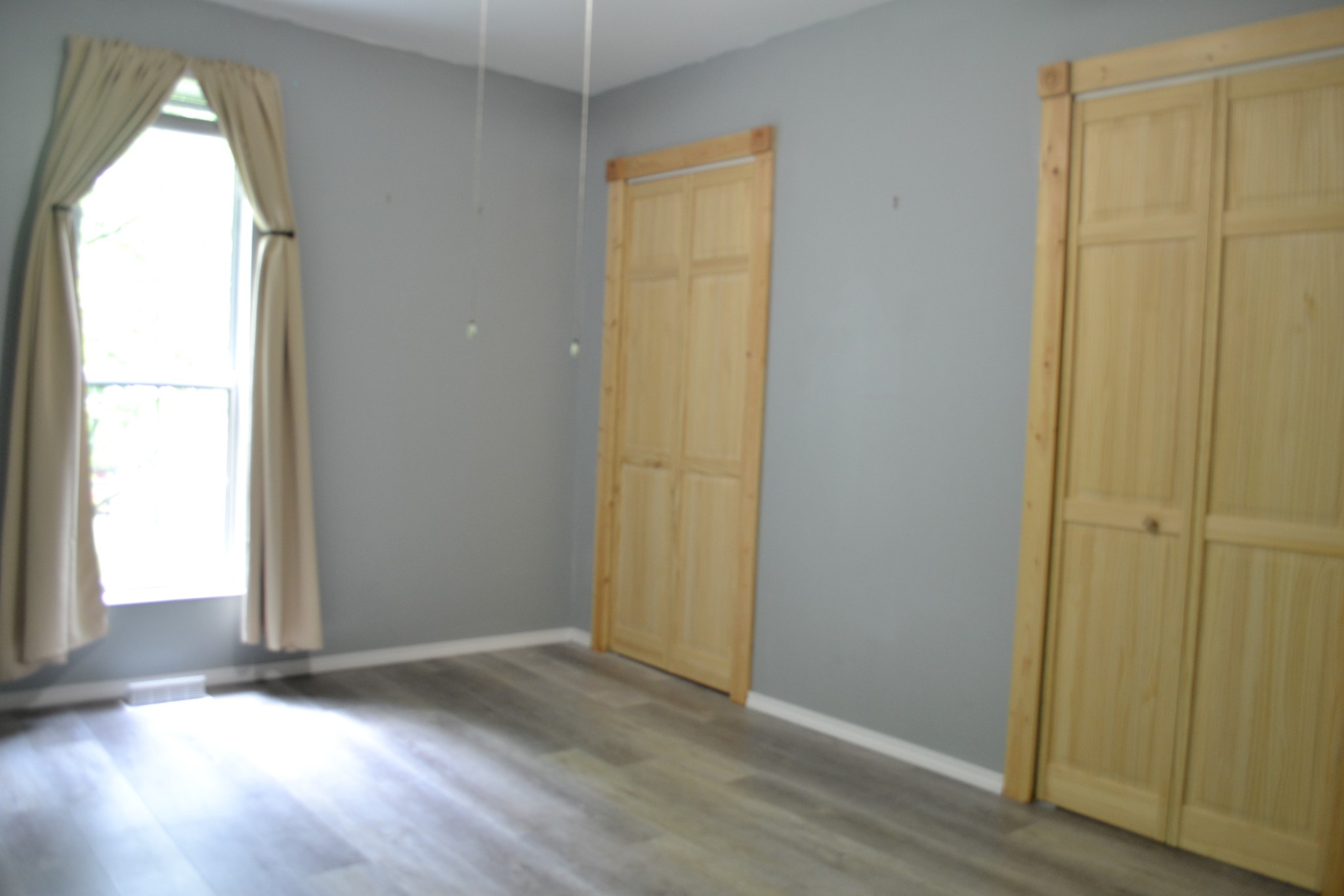 1505 Add Stafford Road Hilham, TN 38568 - Photo 13 of 65 an empty room with wooden floor and windows