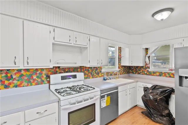 a kitchen with a stove a sink and a refrigerator
