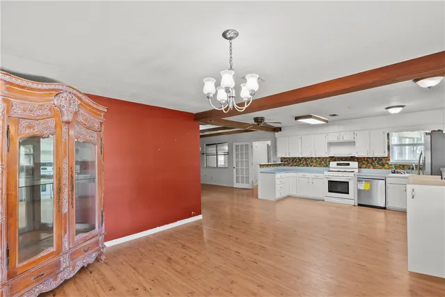 a kitchen with stainless steel appliances granite countertop a refrigerator and a stove top oven