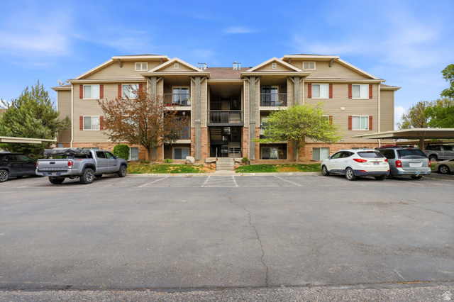 View of property with uncovered parking