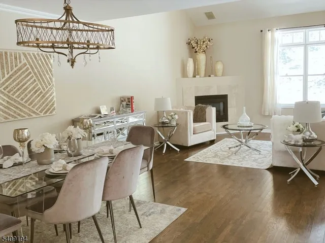 a view of a dining room with furniture wooden floor and a chandelier