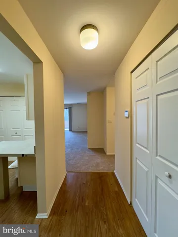 a view of a room with wooden floor and bench