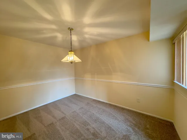 a small space with a hardwood floor and a ceiling fan