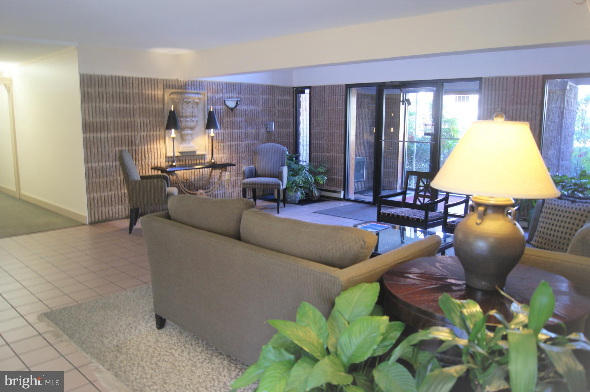 2901 Fallstaff Road, Unit 205 Baltimore, MD 21209 - Photo 3 of 24 a living room with furniture and a chandelier