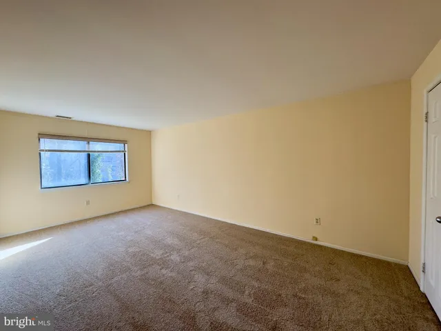 an empty room with a empty space and window
