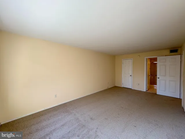 a view of an empty room and closet area