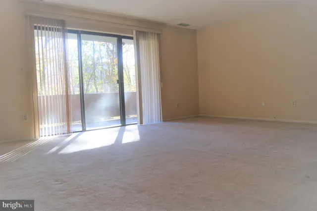 a view of an empty room with a chandeliers