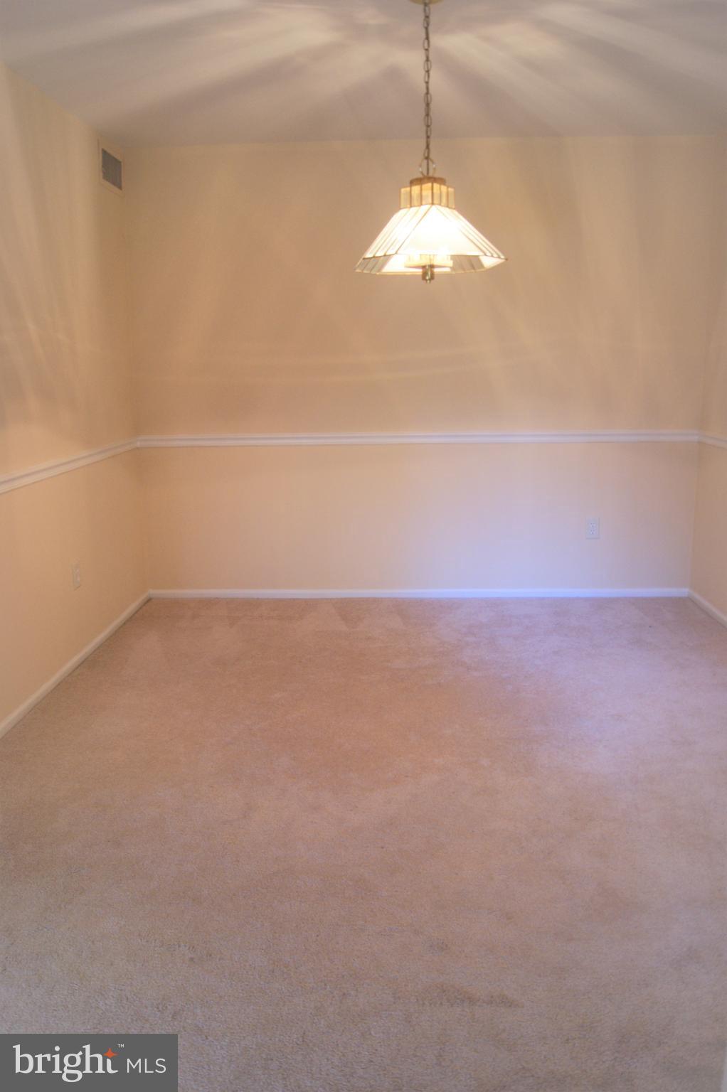 2901 Fallstaff Road, Unit 205 Baltimore, MD 21209 - Photo 8 of 24 a view of an empty room with a chandeliers