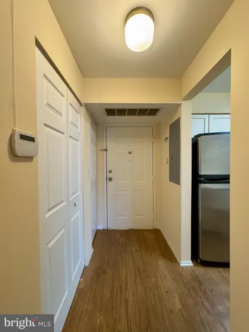 a view of a hallway with wooden floor