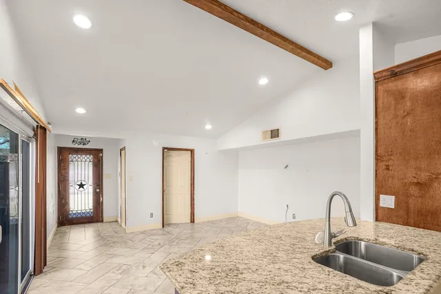 a kitchen with a sink and a refrigerator